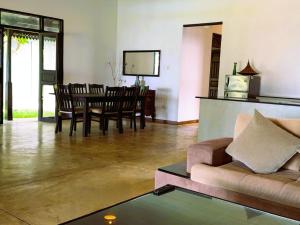 a living room with a couch and a table at Luvora Villa in Ambalangoda