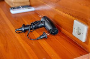 a flashlight sitting on a wooden table with a microphone at Lavanya Villa in Nusa Penida