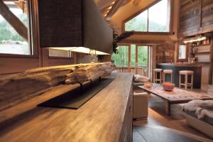 a kitchen with a counter top and a living room at Les Alpages d'Auguste in Valloire