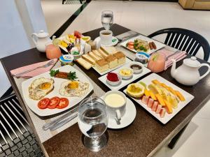 a table with plates of breakfast food on it at H M C Leisure Villa Devinuwara in Dondra North