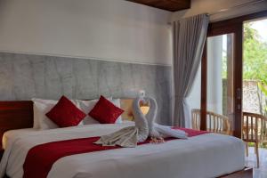 a bedroom with a large bed with a swan on it at Lavanya Villa in Nusa Penida +45 photos