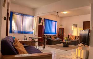 a living room with a couch and a tv at Great location Groundfloor near Calzada in León