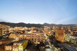 een uitzicht op een stad 's nachts met gebouwen bij Apartment Hotel YAEZAKI in Wada