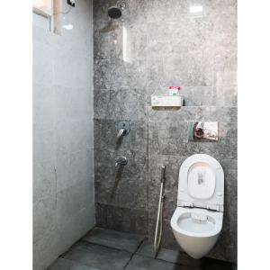 a bathroom with a toilet and a shower at Kimaya's Abode in Chandīgarh +20 photos
