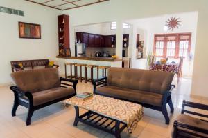 a living room with two couches and a coffee table at Abalone Stay in Bentota