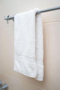 a white towel hanging on a towel rack in a bathroom at Abalone Stay in Bentota +83 photos
