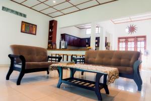 a living room with two couches and a coffee table at Abalone Stay in Bentota
