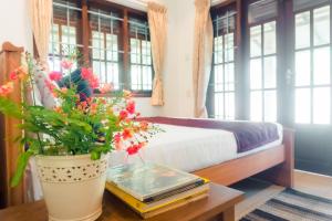 a bedroom with a bed and a table with flowers at Abalone Stay in Bentota
