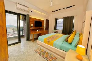 een slaapkamer met een groot bed en een televisie bij Hotel Aura Residency By Sitara Group, Haridwar in Haridwār