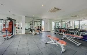 a gym with treadmills and equipment in a building at Mansion 51 Hotel & Apartment in Phnom Penh