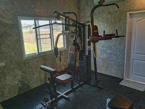 a room with a gym with a treadmill at VicaWorld in Prathai