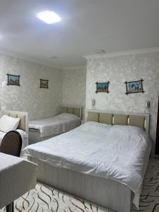 a bedroom with two beds in a room at Imran&Bek in Samarkand