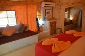 a bedroom with two beds in a log cabin at Dolphin Beach Resort in Kalpitiya