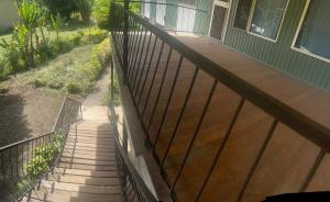 a wooden porch with a fence on a house at GOROKA Home Stay in Goroka