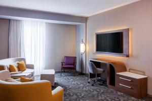 a hotel room with a desk and a tv at Courtyard by Marriott Mexicali in Mexicali
