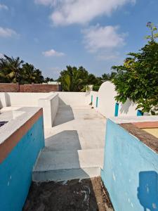 a set of stairs with blue and white walls at Nilan Aarudhra Homestay in Chidambaram