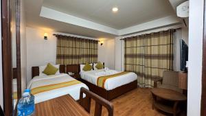 una camera d'albergo con due letti e un tavolo di Hotel Everest Nepal a Kathmandu