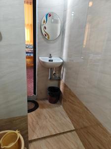 a bathroom with a sink and a mirror at His Grace BEACH AVENUE, Malpe Beach in Udupi +30 photos