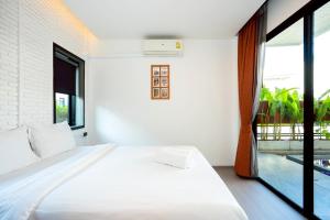 En eller flere senge i et værelse på Le Villa Huahin + 33 billeder