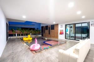 a living room with a pool with a pool toy at Le Villa Huahin in Hua Hin