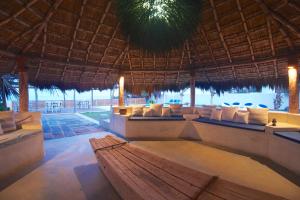a pavilion with pillows and a bench in a resort at Dolphin Beach Resort - Dolphines, Kitesurfing & Wildlife in Kalpitiya