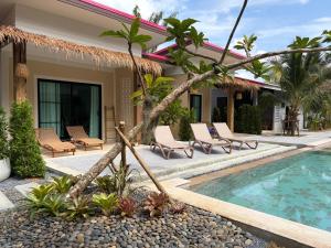 a villa with a swimming pool and a resort at Pinky Bungalows Resort & Villa in Ko Lanta