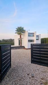 a house with two gates in front of a palm tree at Interno 8 in Padova