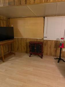 een kamer met een flatscreen-tv, een tafel en een raam bij Park Model Furnished #5 in Tucson