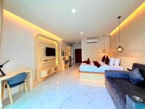 a hotel room with two beds and a couch at Pure Sand Lanta Resort in Ko Lanta