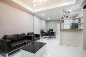 een woonkamer met een bank en een tafel bij K Station Pattaya in Pattaya