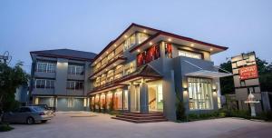 a building with a car parked in front of it at Soontree House Hotel in Udon Thani
