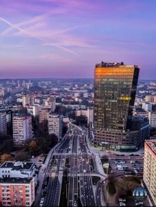 a view of a city with a tall building at Hanza Tower Level XV Signature in Szczecin
