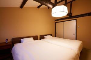 two beds sitting next to each other in a bedroom at Rinn Kujofujinoki West in Kyoto
