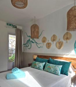 a bedroom with a bed and an octopus on the wall at Villa detente 1 in Saint Gabriel