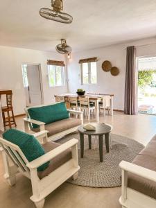 a living room with a couch and a table at Villa detente 1 in Saint Gabriel