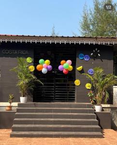 a group of colorful balloons hanging from a building at Costa Rica in Kumta