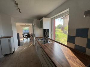 an empty kitchen with a sink and a window at Pure nature - Dein Landhaus in Wardow