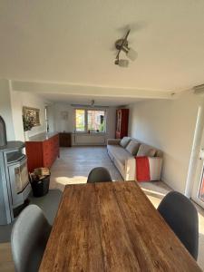 a living room with a wooden table and a couch at Pure nature - Dein Landhaus in Wardow