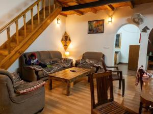 ein Wohnzimmer mit zwei Sofas und einem Tisch in der Unterkunft Rooptara Valley Luxury Cottage Majkhali Himalaya in Rānīkhet
