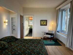 a bedroom with a bed and a desk and a window at Aux étangs fleuris in Rochefort +102 photos