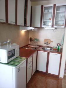 a small kitchen with a sink and a microwave at Studios in Complex Elit 4 in Sunny Beach
