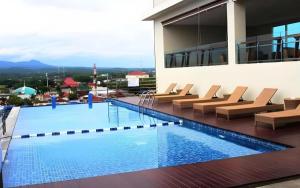a swimming pool on the roof of a building at Java Lotus Hotel Jember in Jember