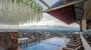 a view of a swimming pool on top of a building at Java Lotus Hotel Jember in Jember