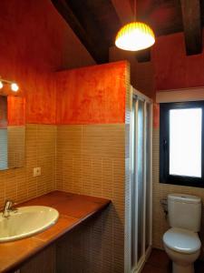 a bathroom with a sink and a toilet and a window at La Casona del Silencio in Canos