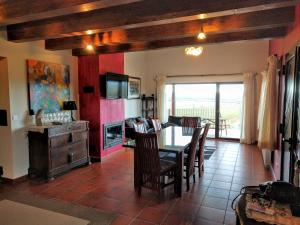a living room with a table and chairs and a television at La Casona del Silencio in Canos