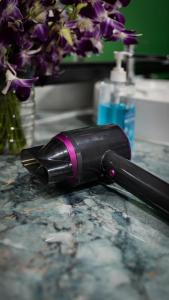 a black wine bottle sitting on a counter next to a sink at The Highdogs Hostel in Phi Phi Islands