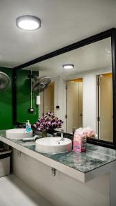 a bathroom with two sinks and a large mirror at The Highdogs Hostel in Phi Phi Islands +22 photos