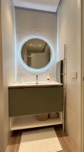 a bathroom with a sink and a mirror at Brezza di mare home con garage in Civitanova Marche