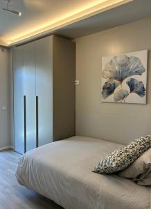a bedroom with a large bed and a cabinet at Brezza di mare home con garage in Civitanova Marche