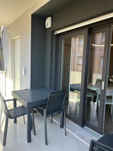 a black table and chairs on a balcony with a table and chairs at Brezza di mare home con garage in Civitanova Marche